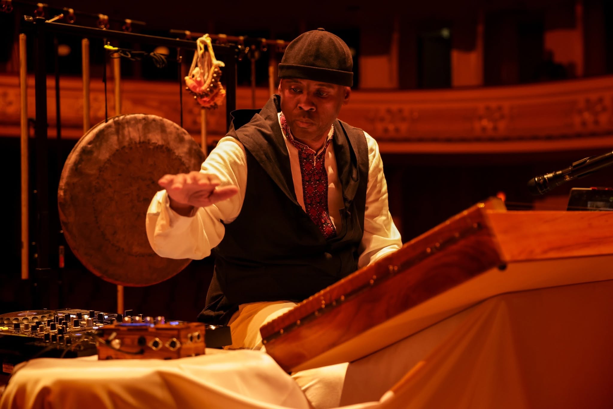 Shannon Harris performing with a gong and DJ equipment